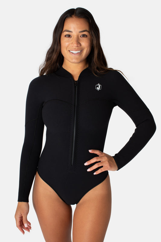 Jonesea Black La Cheeky Springsuit – Front view of handmade women's neoprene wetsuit in Black, long sleeve, front zip, hand on hip, white background