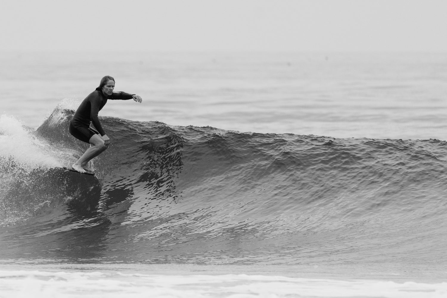 Jonesea surfing in the men’s long-arm springsuit, hanging ten with style and control.