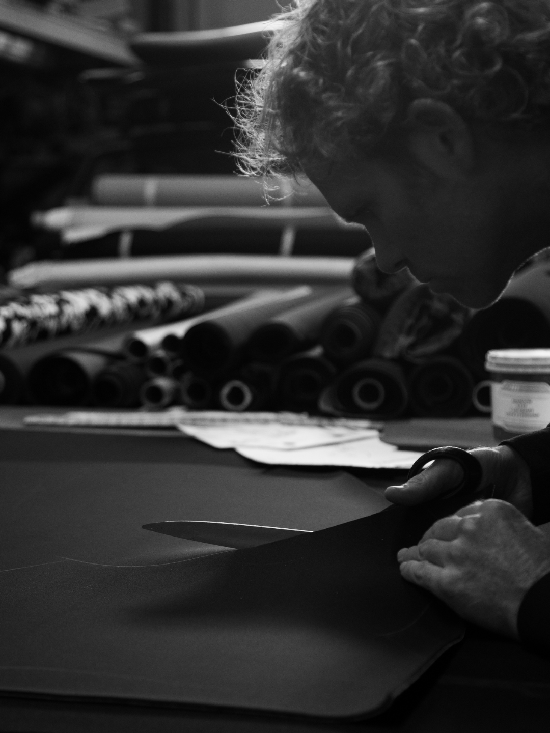 Shane Jones cutting handmade wetsuit California studio