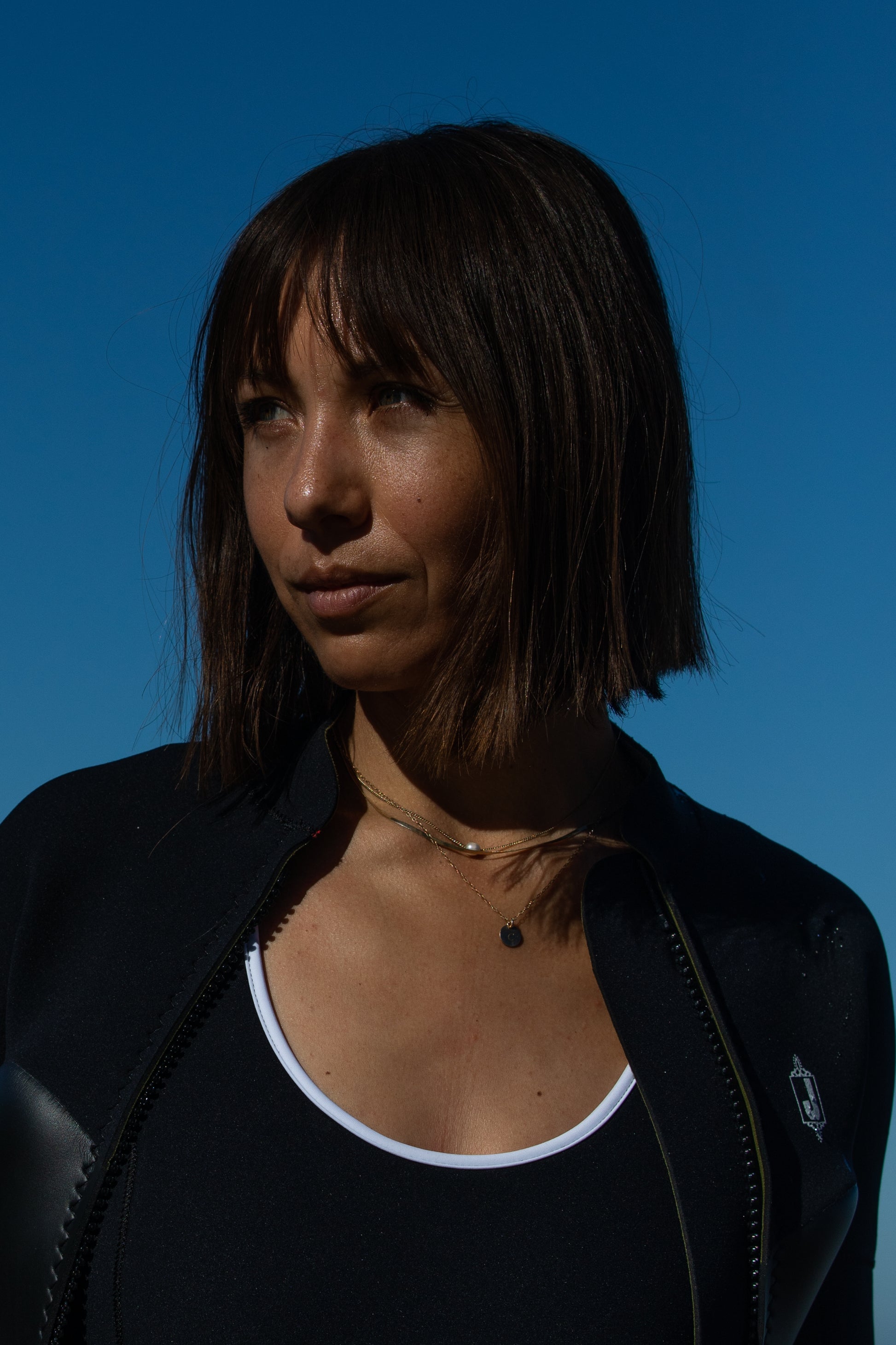 Premium black wetsuit with Yamamoto limestone-based material - handcrafted custom wetsuits.