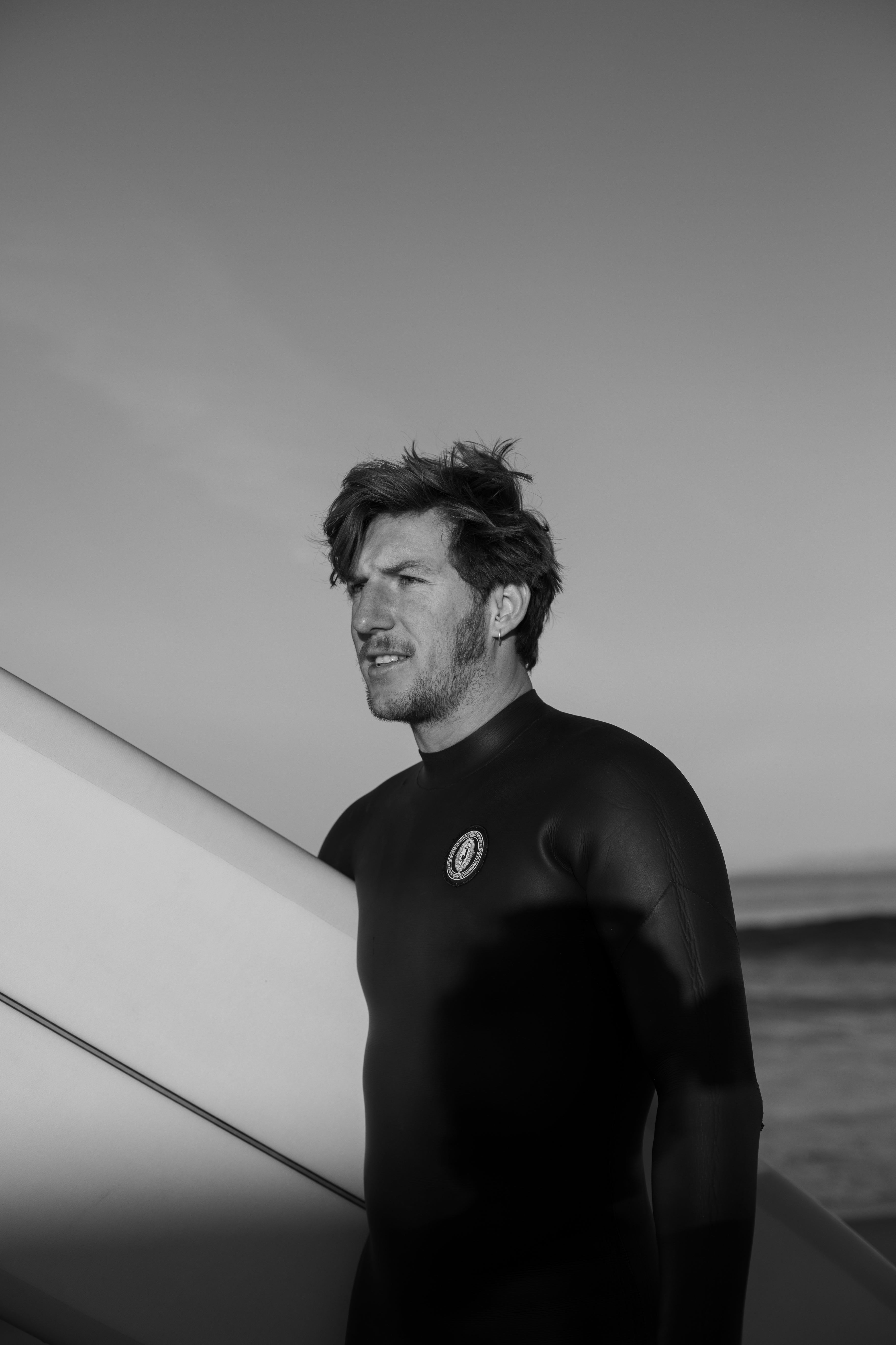 man in custom wetsuit for surfing