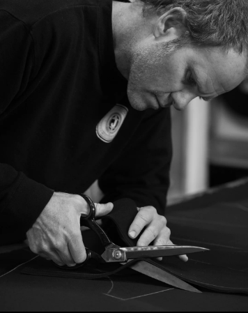 man cutting custom wetsuit