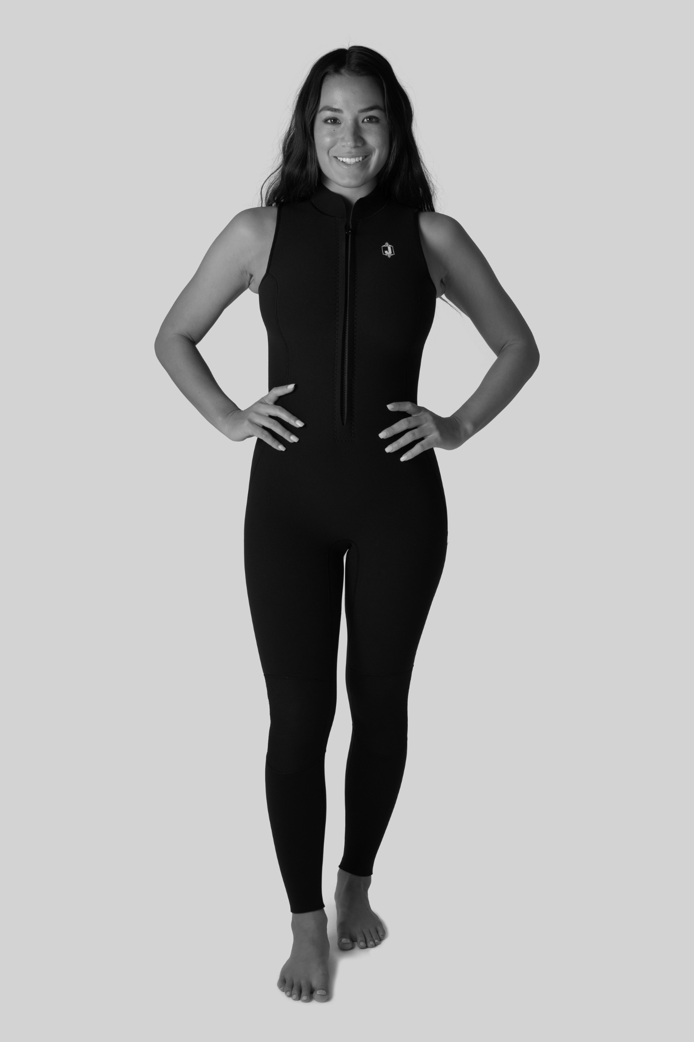 Person wearing a black wetsuit on a light gray background
