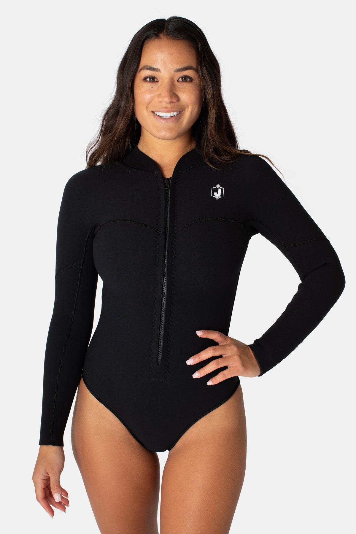 Jonesea Black La Cheeky Springsuit – Front view of handmade women's neoprene wetsuit in Black, long sleeve, front zip, hand on hip, white background